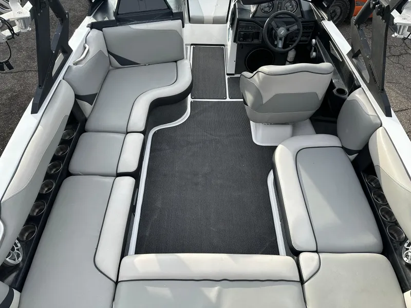 Slide: The Image of 2016 Axis Boats T22 interior with gray seating and black flooring. - 10
