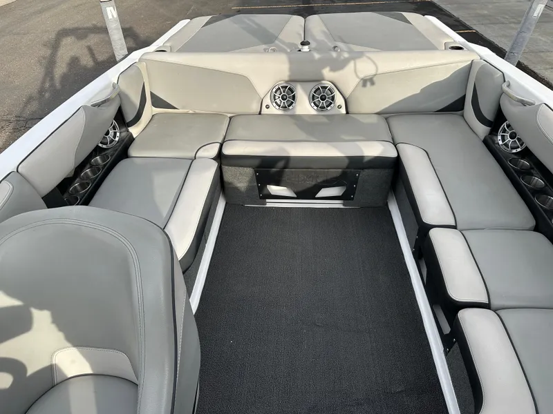 Slide: The Image of 2016 Axis Boats T22 interior with gray seating and built-in speakers. - 12