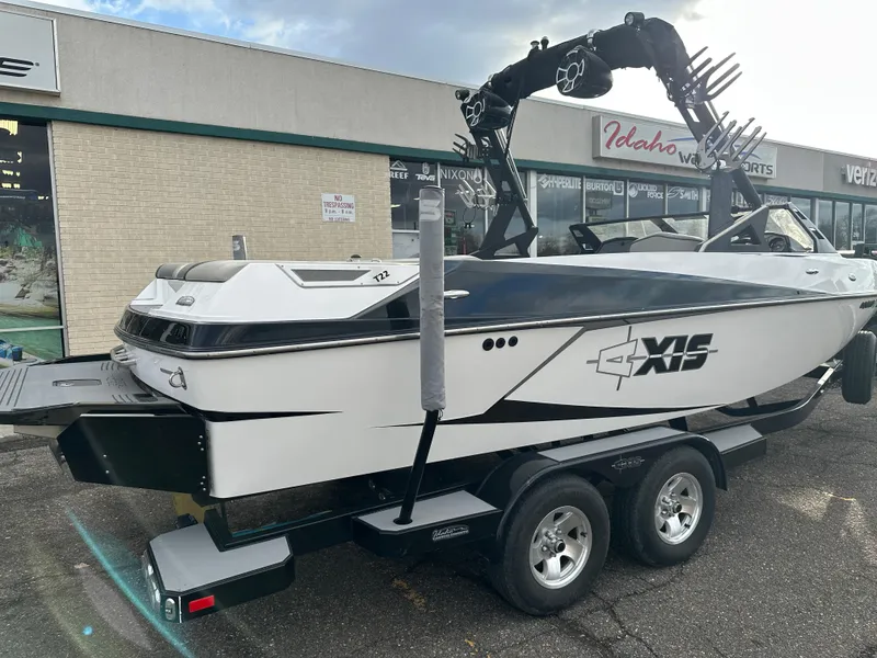 Slide: The Image of 2016 Axis Boats T22 on trailer outside Idaho Water Sports store. - 4