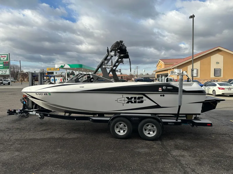 Slide: The Image of 2016 Axis Boats T22 on trailer in parking lot, overcast sky. - 7