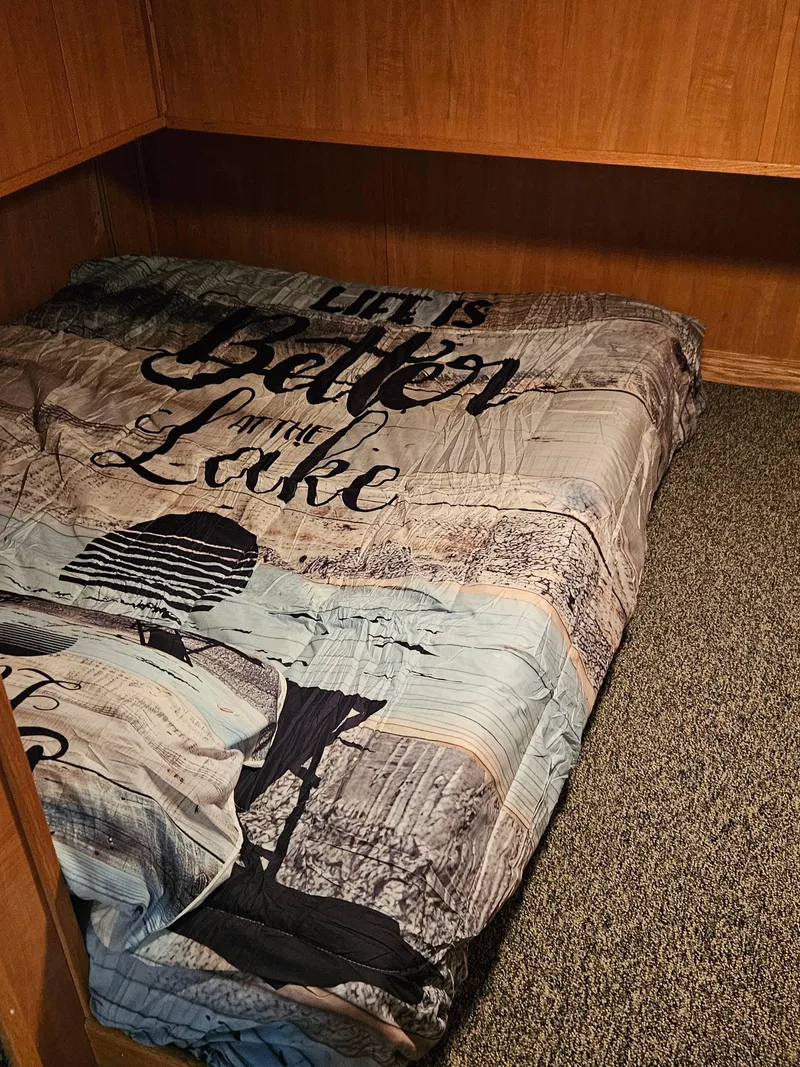 Slide: The Image of Cozy bedroom in 1997 Sumerset Houseboat with lake-themed bedding. - 11