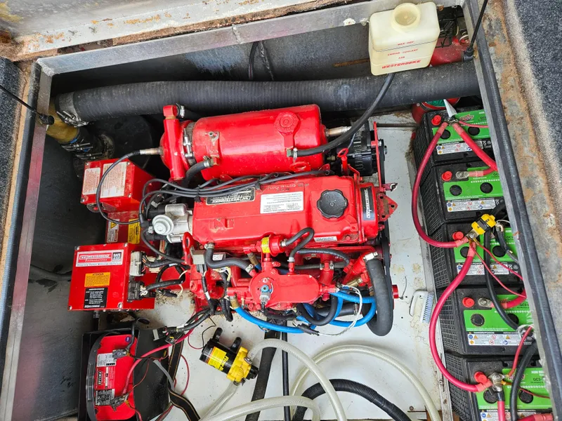 Slide: The Image of Engine compartment of a 1997 Sumerset Houseboat with batteries and wiring. - 14