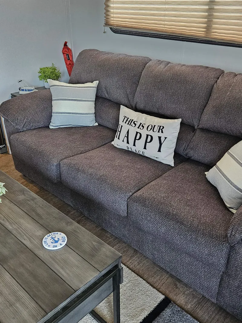 Slide: The Image of Cozy living area in 1997 Sumerset Houseboat with gray sofa and decorative pillows. - 16