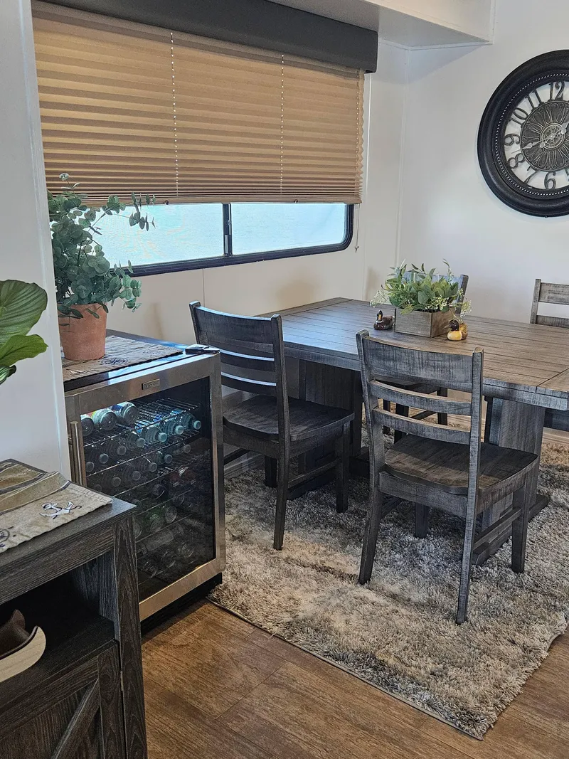 Slide: The Image of Dining area in 1997 Sumerset Houseboat with wooden table, chairs, and wine cooler. - 17