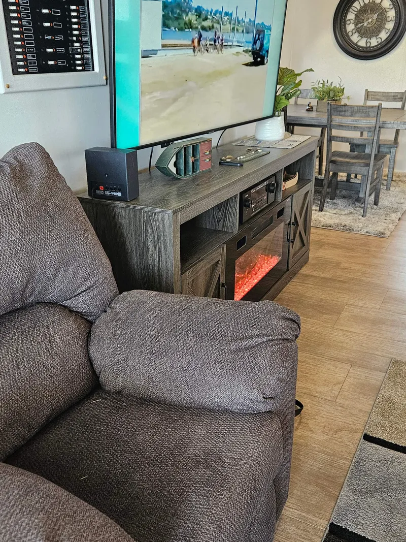 Slide: The Image of Cozy houseboat interior with plush sofa, TV, and electric fireplace, 1997 Sumerset model. - 18