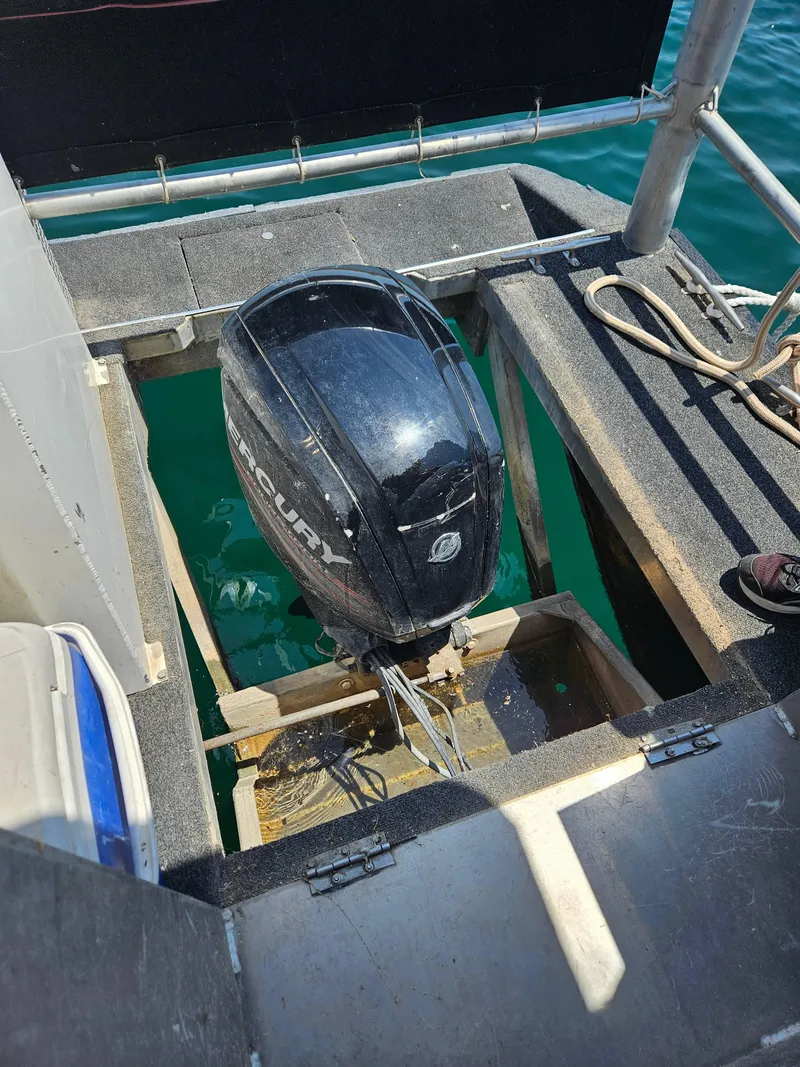 Slide: The Image of 1997 SUMERSET HOUSEBOATS houseboat with Mercury outboard motor in open compartment on water. - 7