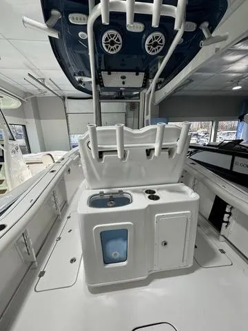 Slide: The Image of 2024 Tidewater 272 CC Adventure boat interior with rod holders and storage compartments. - 11