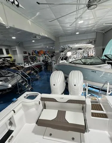 Slide: The Image of 2024 Tidewater 272 CC Adventure boat in showroom with dual engines. - 15