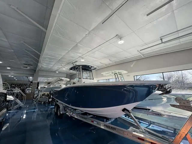 Slide: The Image of 2024 Tidewater 272 CC Adventure boat displayed indoors on a trailer. - 4