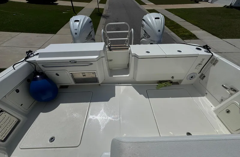 Slide: The Image of 2022 World Cat 400 DC-X boat deck with dual engines and storage compartments. - 12