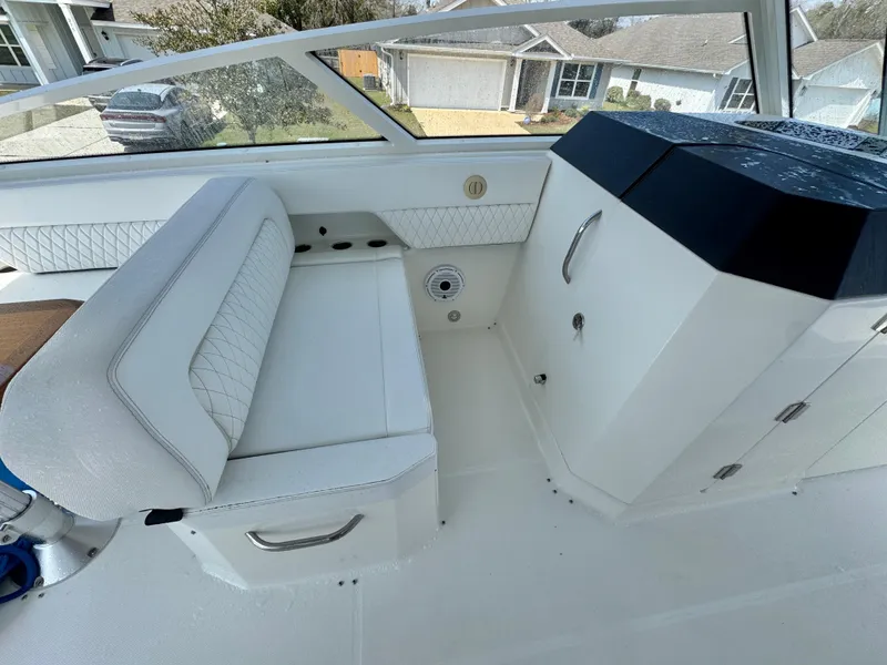 Slide: The Image of Interior of 2022 World Cat 400 DC-X boat with white seating and cabinetry. - 15