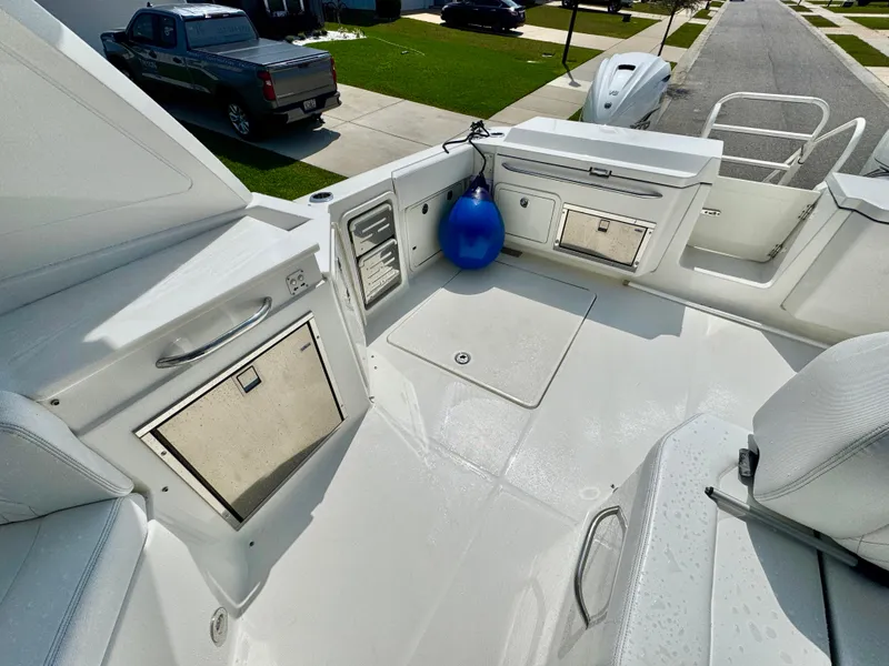 Slide: The Image of 2022 World Cat 400 DC-X boat deck with storage compartments and blue fender. - 16