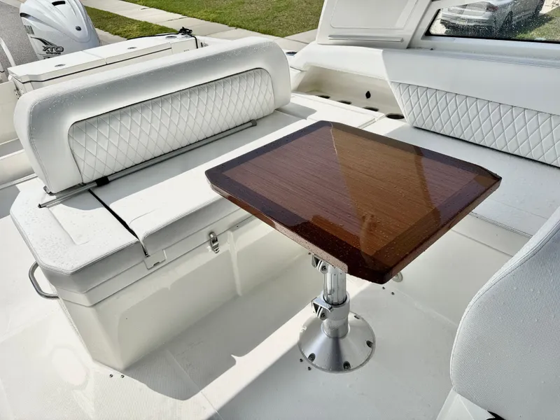 Slide: The Image of Luxurious seating area on 2022 World Cat 400 DC-X boat with elegant wooden table. - 17
