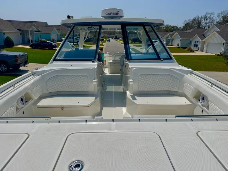 Slide: The Image of 2022 World Cat 400 DC-X boat with spacious seating and Garmin navigation, parked in a residential area. - 21