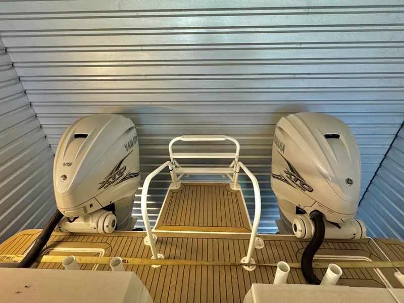 Slide: The Image of 2022 World Cat 400 DC-X boat with twin Yamaha outboard engines in storage. - 24