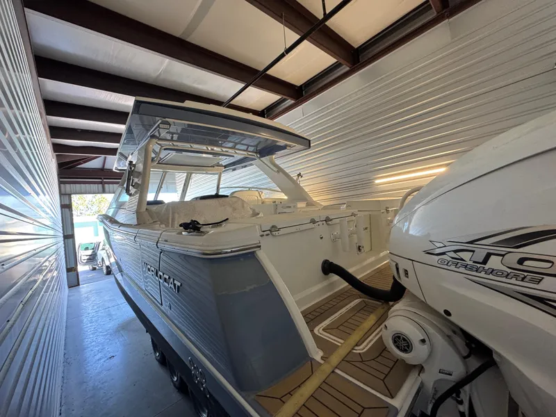 Slide: The Image of 2022 World Cat 400 DC-X boat in storage, featuring dual outboard engines. - 27