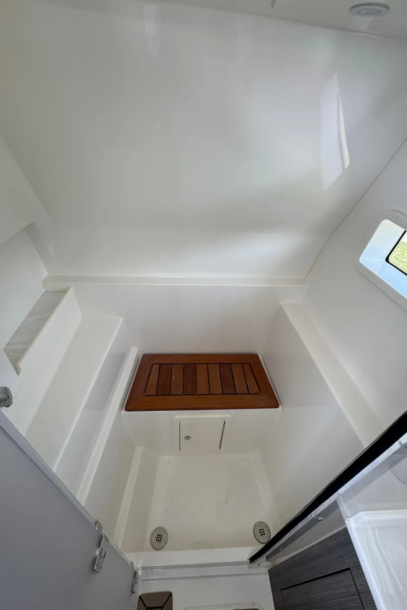 Slide: The Image of 2022 World Cat 400 DC-X interior cabin with wooden accents and window. - 34
