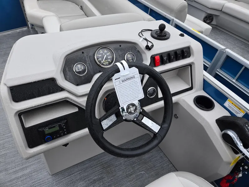 Slide: The Image of 2025 Godfrey Xperience 2286 SBX boat dashboard with steering wheel and controls. - 10