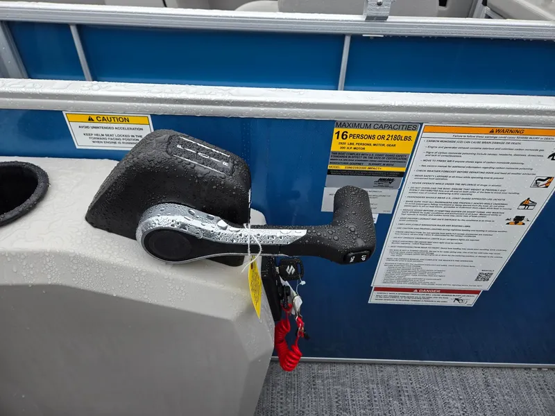 Slide: The Image of Control lever on 2025 Godfrey Xperience 2286 SBX boat with safety warnings. - 13