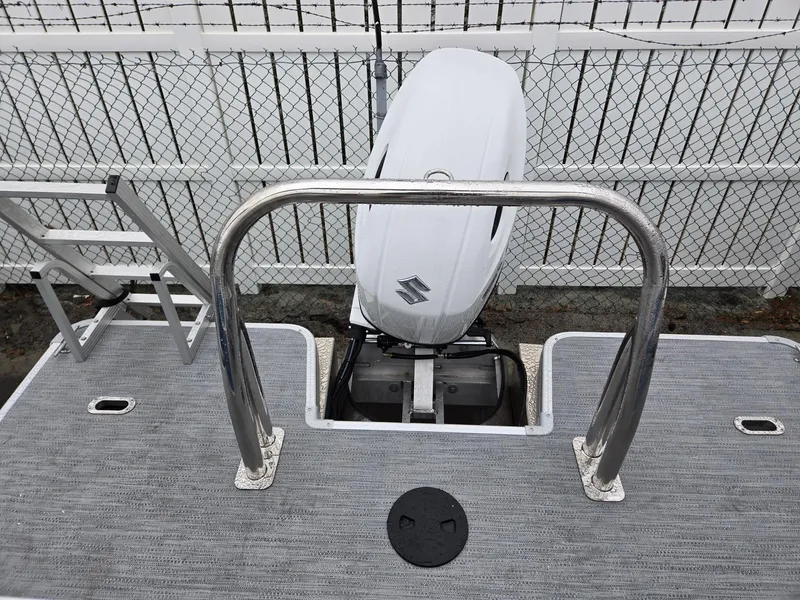 Slide: The Image of 2025 Godfrey Xperience 2286 SBX boat with Suzuki outboard motor, rear view. - 17