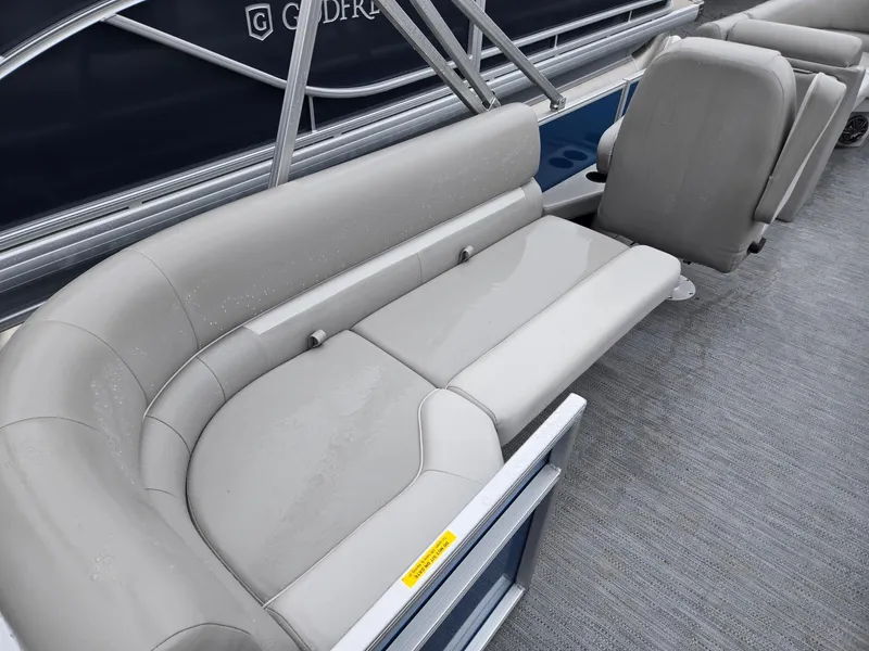 Slide: The Image of 2025 Godfrey Xperience 2286 SBX boat interior with gray seating and carpeted floor. - 21