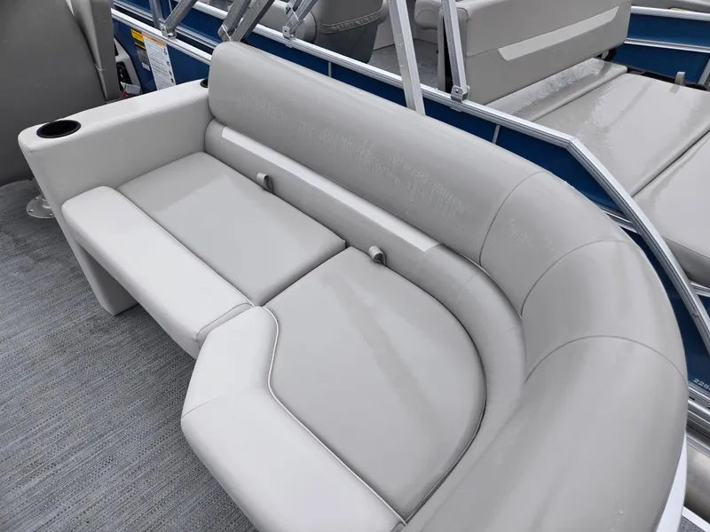 Slide: The Image of 2025 Godfrey Xperience 2286 SBX boat interior with gray seating and cup holder. - 22