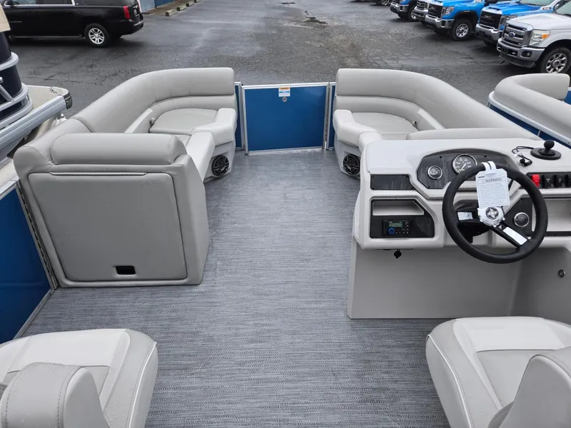 Slide: The Image of 2025 Godfrey Xperience 2286 SBX pontoon boat interior with gray seating and steering console. - 23