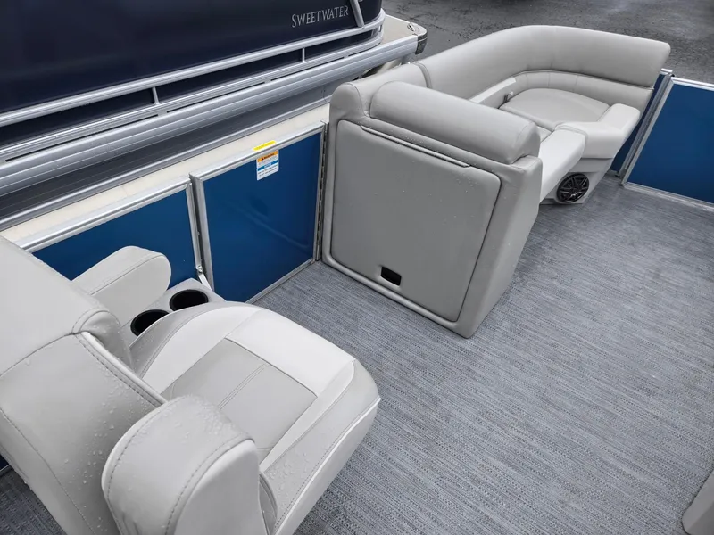 Slide: The Image of 2025 Godfrey Xperience 2286 SBX pontoon boat interior with gray seating and blue paneling. - 24