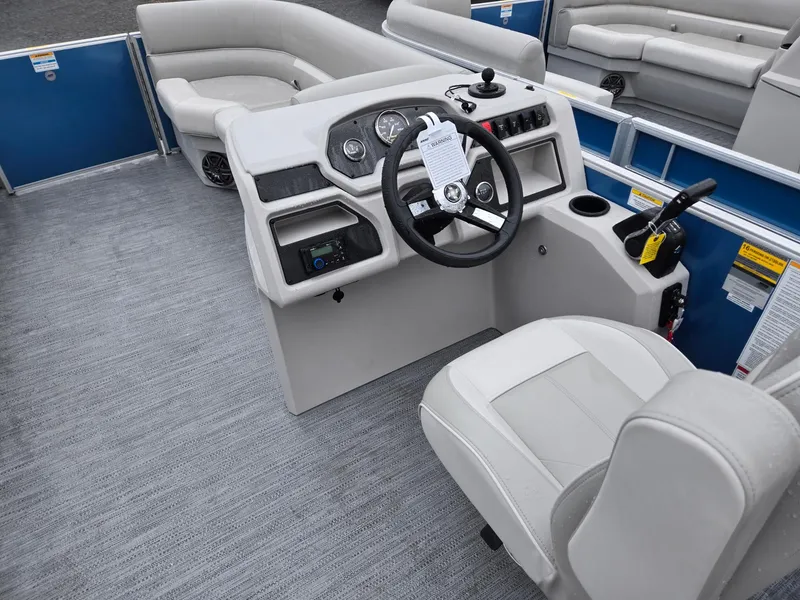 Slide: The Image of 2025 Godfrey Xperience 2286 SBX boat interior with steering console and seating. - 25