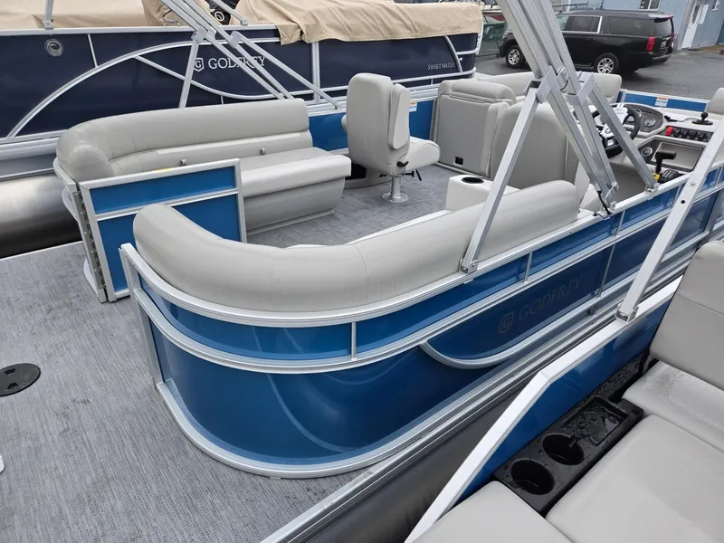 Slide: The Image of 2025 Godfrey Xperience 2286 SBX pontoon boat with blue exterior and spacious seating. - 3