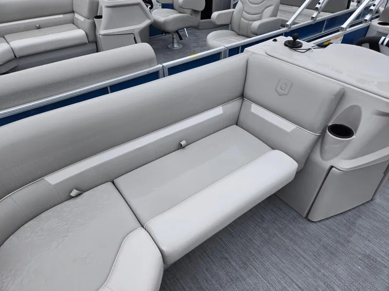 Slide: The Image of 2025 Godfrey Xperience 2286 SBX pontoon boat interior with gray seating and cup holder. - 5