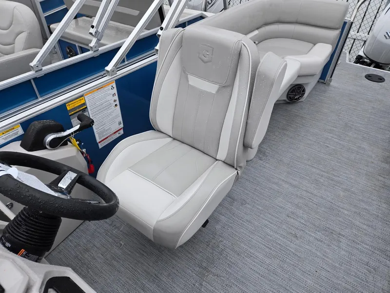 Slide: The Image of 2025 Godfrey Xperience 2286 SBX boat interior with plush seating and steering wheel. - 9