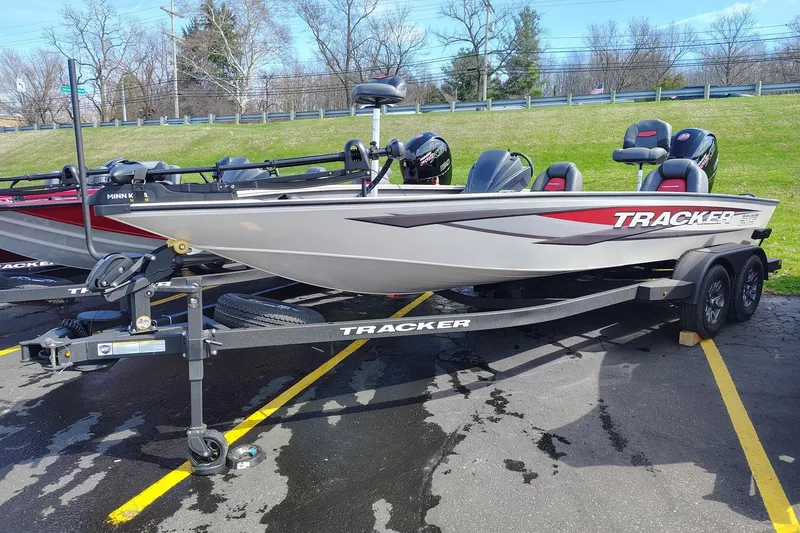 The Image of 2025 Tracker Savage 215 boat on trailer, parked in lot, sunny day. - 0