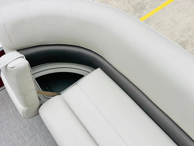 Slide: The Image of 2025 Sun Tracker Party Barge 18 DLX interior seating, featuring plush, light gray upholstery. - 21