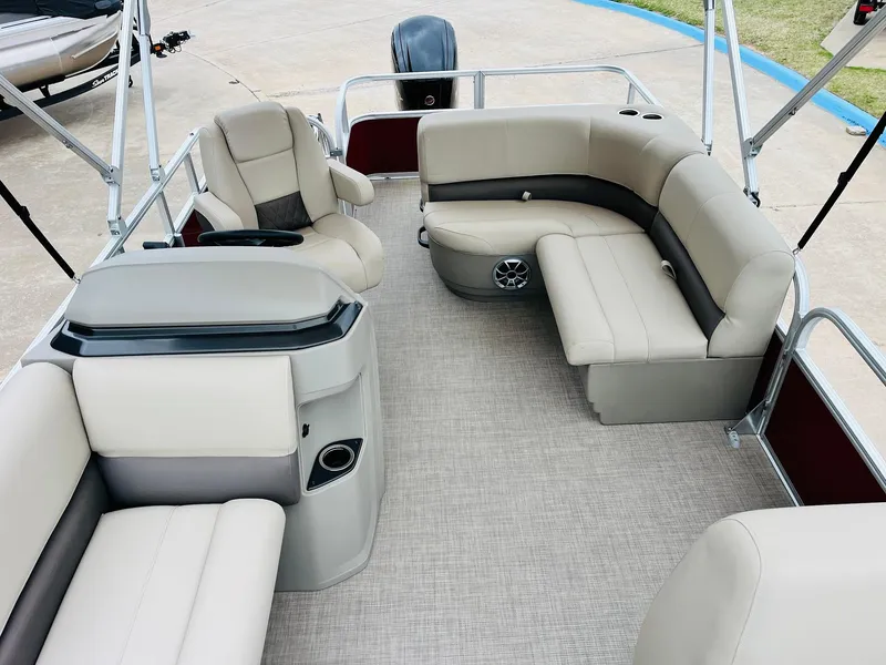 Slide: The Image of 2025 Sun Tracker Party Barge 18 DLX interior with beige seating and spacious layout. - 23