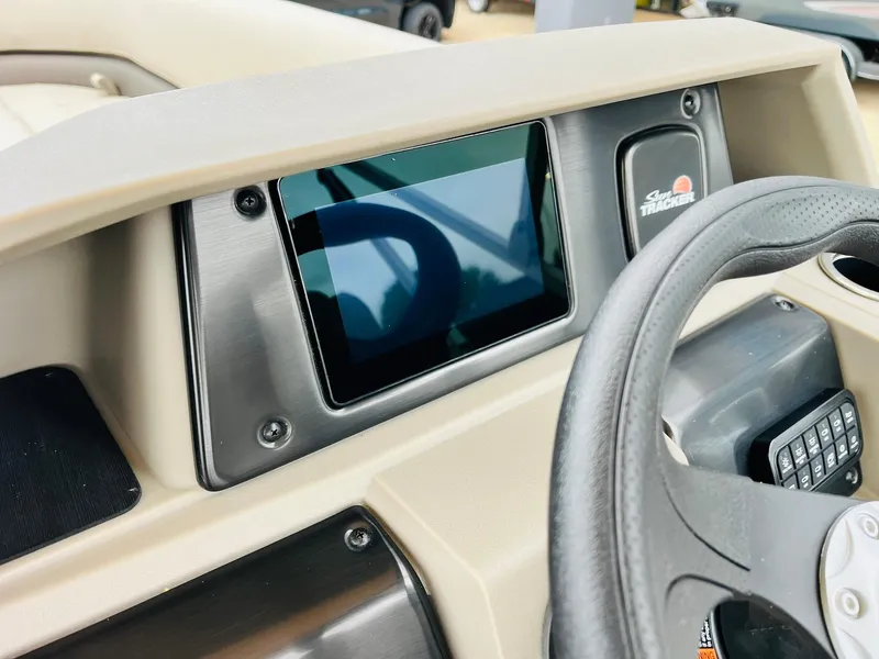 Slide: The Image of 2025 Sun Tracker Party Barge 18 DLX dashboard with touchscreen and steering wheel. - 30
