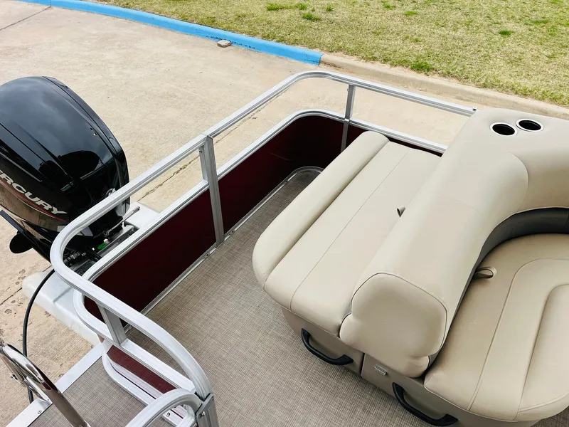 Slide: The Image of 2025 Sun Tracker Party Barge 18 DLX with beige seating and outboard motor. - 34