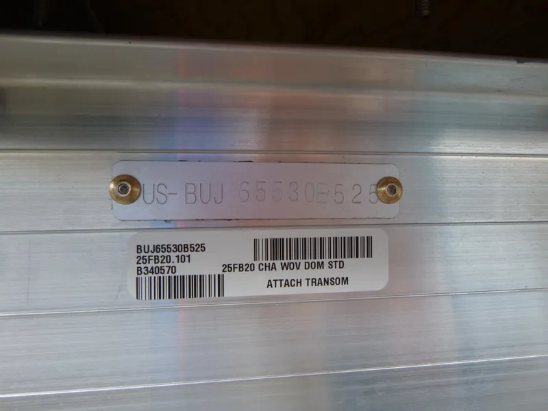 Slide: The Image of 2025 Sun Tracker Fishin' Barge 20 DLX transom with identification plate and barcode. - 19