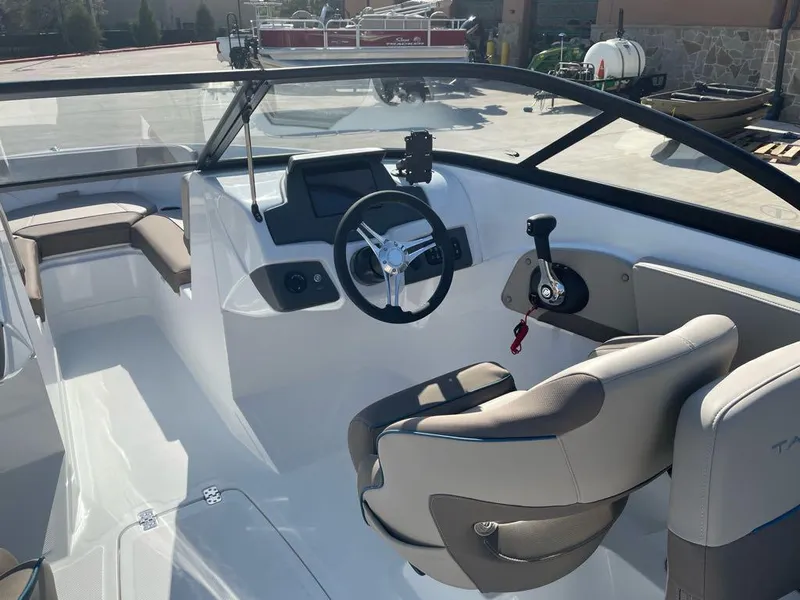 Slide: The Image of 2025 Tahoe 210 S boat interior with steering wheel and seating. - 4
