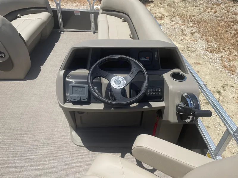Slide: The Image of 2025 Sun Tracker Party Barge 18 DLX steering console with seating and controls. - 10