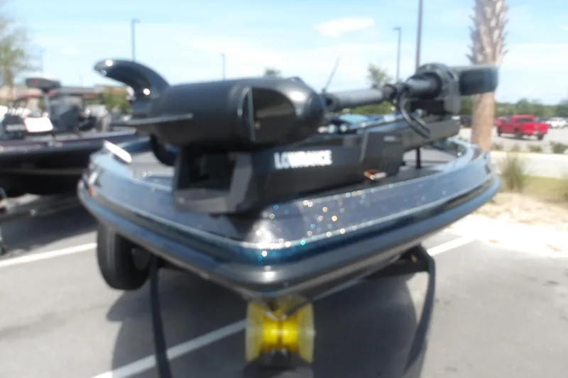Slide: The Image of 2025 Ranger Z518 Cup-Equipped boat with Lowrance equipment, parked outdoors. - 2