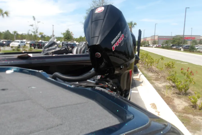 Slide: The Image of 2025 Ranger Z518 Cup-Equipped boat with powerful outboard motor in a parking lot. - 4