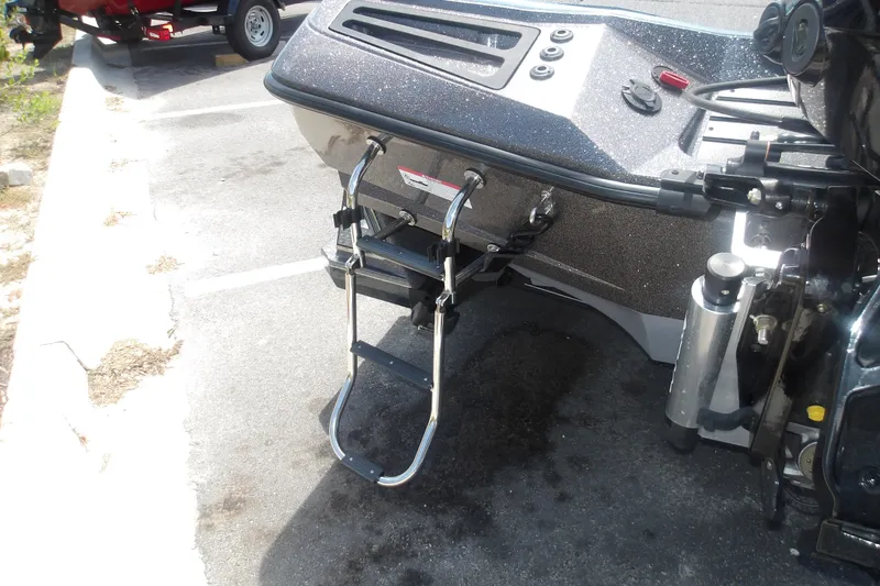 Slide: The Image of 2025 Ranger Z518 Cup-Equipped boat with ladder, parked on asphalt. - 6