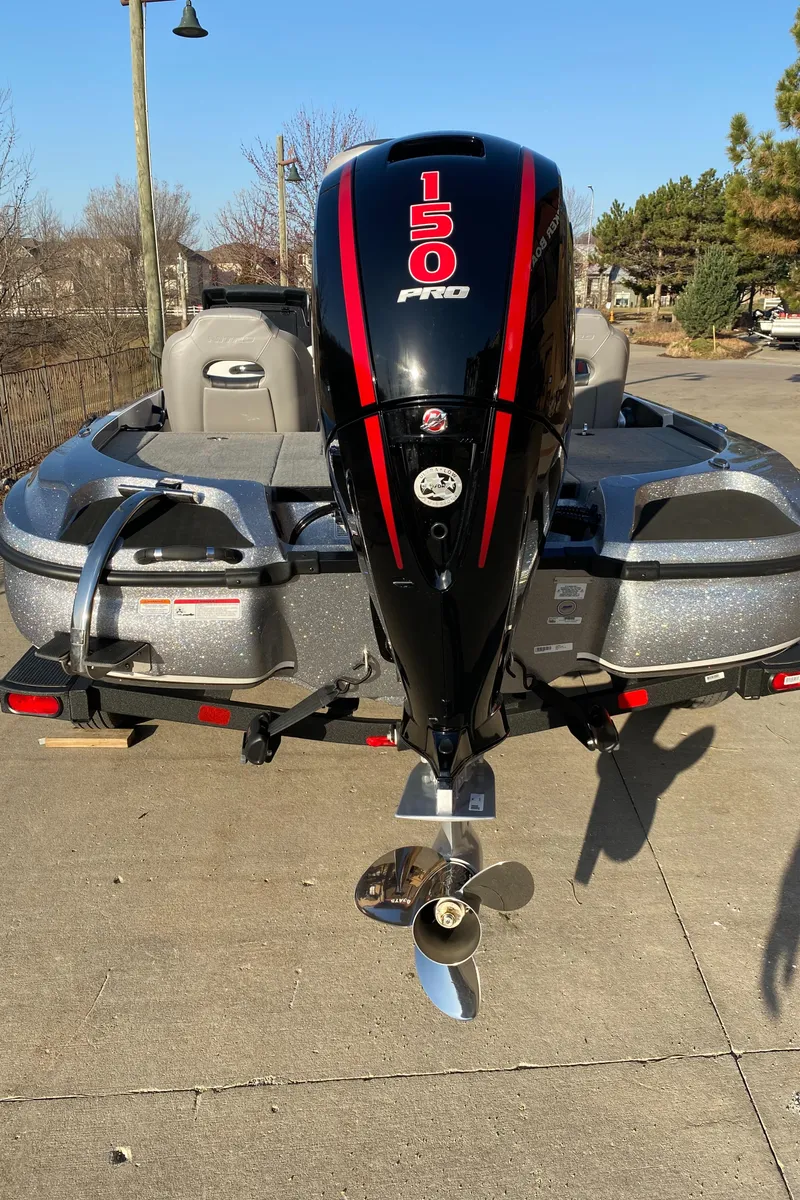 Slide: The Image of 2025 Nitro Z18 boat with 150 Pro outboard motor, parked outdoors. - 1