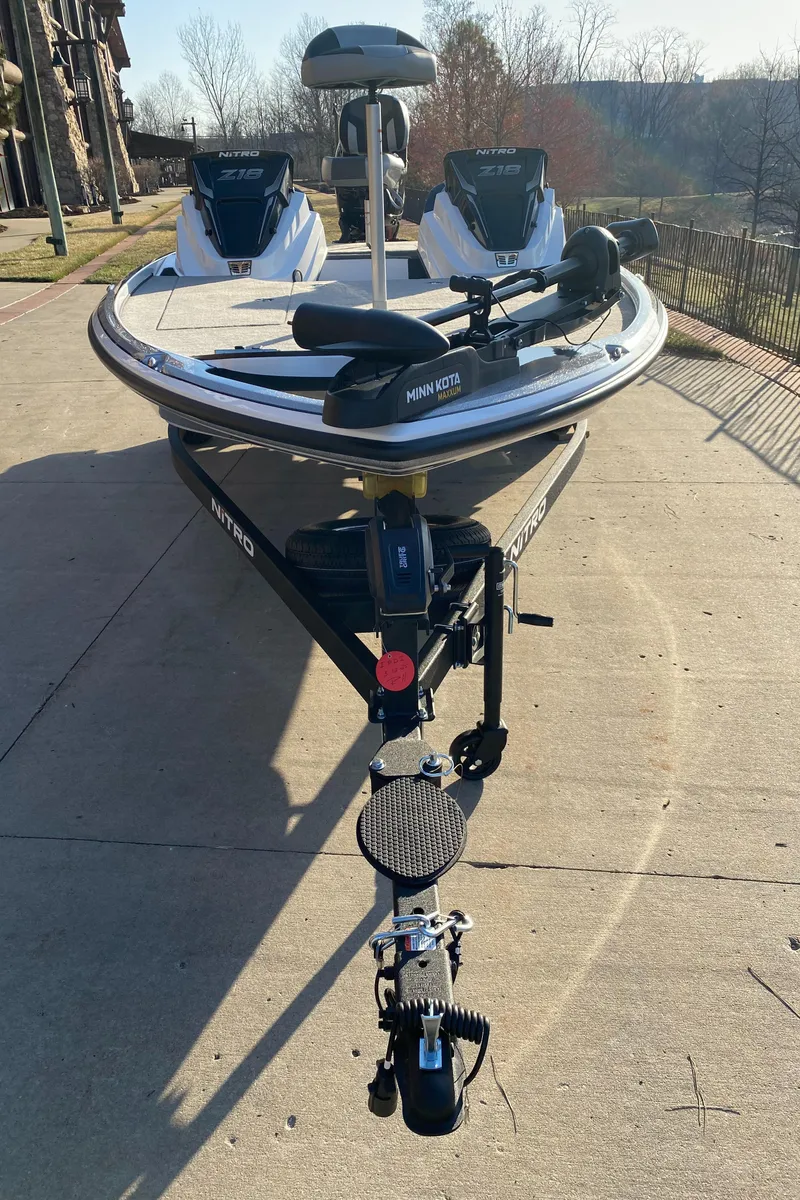 Slide: The Image of 2025 Nitro Z18 boat on trailer, parked outdoors, sunny day. - 2
