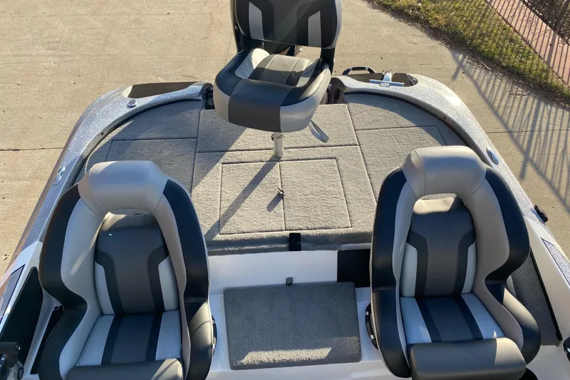Slide: The Image of 2025 Nitro Z18 boat interior with three cushioned seats and spacious deck. - 5