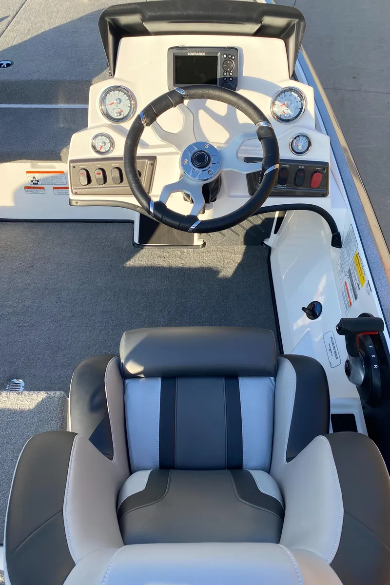 Slide: The Image of 2025 Nitro Z18 boat cockpit with steering wheel and gauges, featuring modern design and comfortable seating. - 6