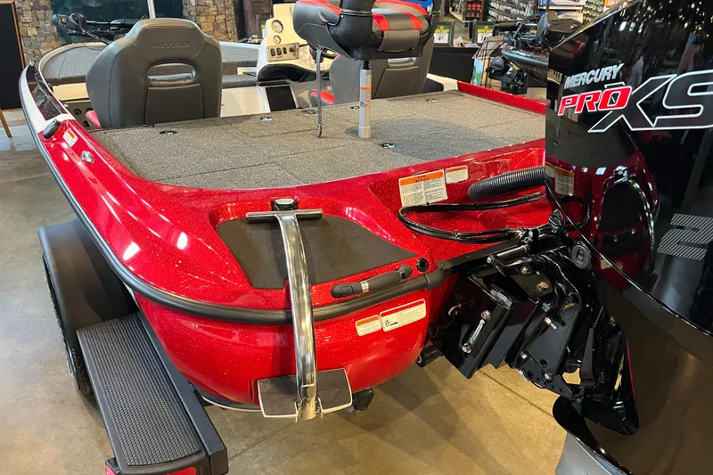 Slide: The Image of Red 2025 Nitro Z19 boat with Mercury Pro XS engine, displayed indoors. - 2