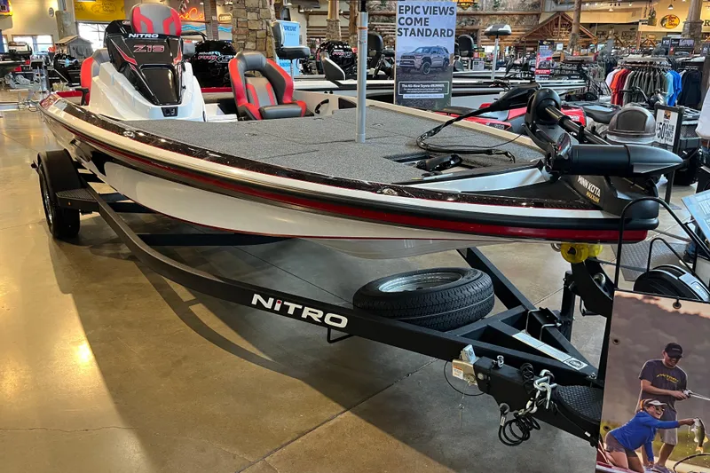 Slide: The Image of 2025 Nitro Z19 boat on display in showroom with trailer. - 98