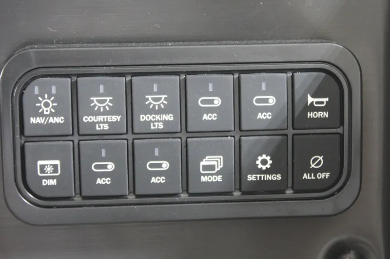 Slide: The Image of Control panel of 2025 Sun Tracker Party Barge 20 DLX with various switches and buttons. - 14